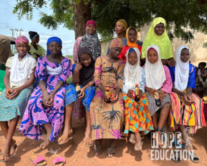 A group of young muslim girls sit under a tree in Dimala, Sagnarigu Municipal, Tamale