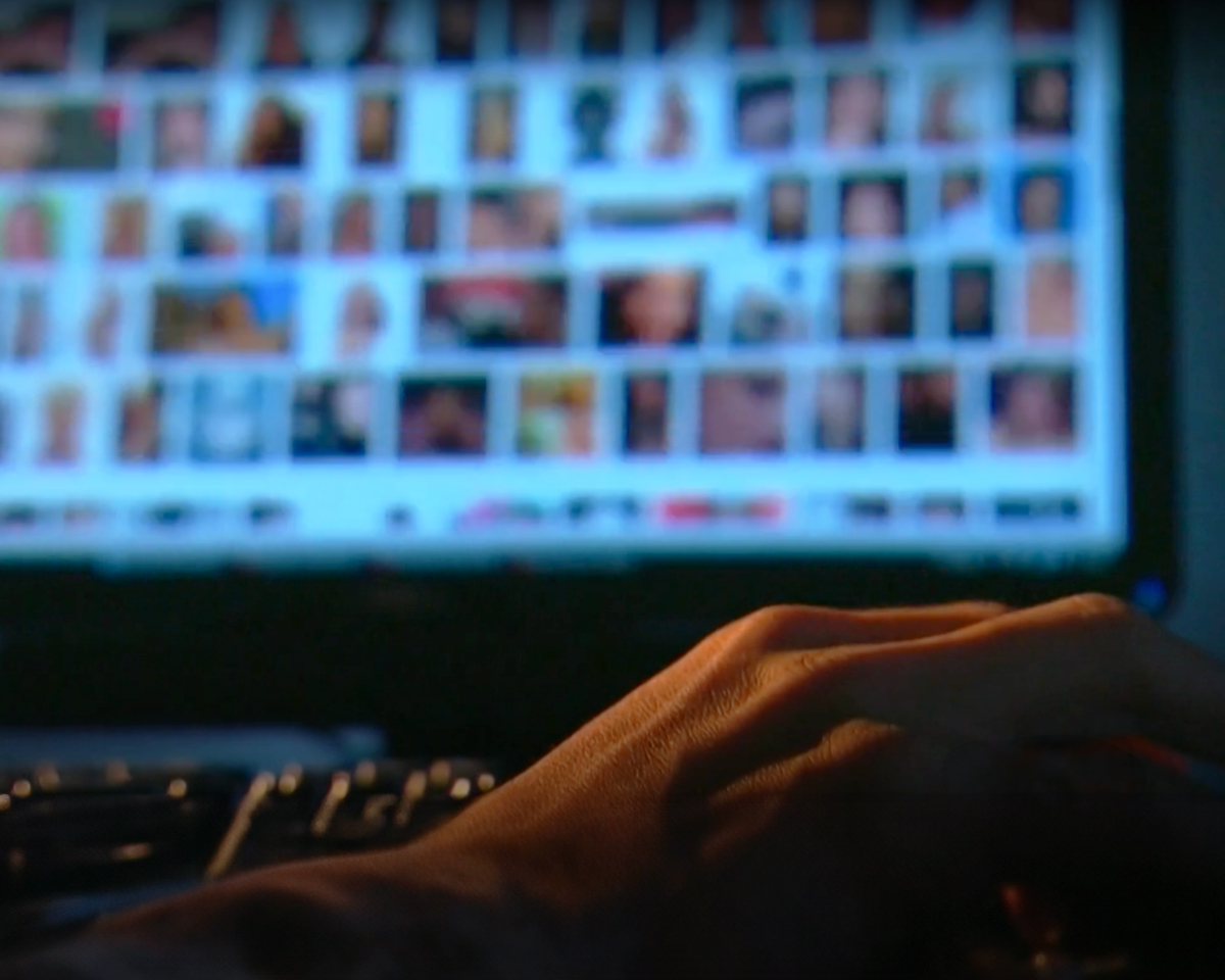 A man searching the internet on his laptop for webcams with sexual content