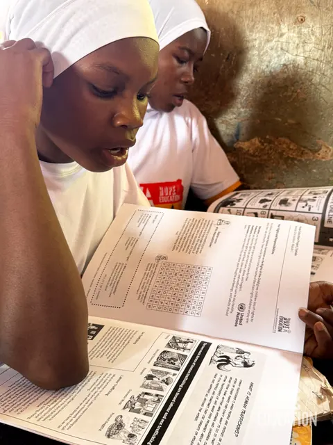 Students at Bagabaga Junior High School, Tamale reading the HEP human trafficking education program handout, filled with cartoons, quizzes, facts and revision notes.