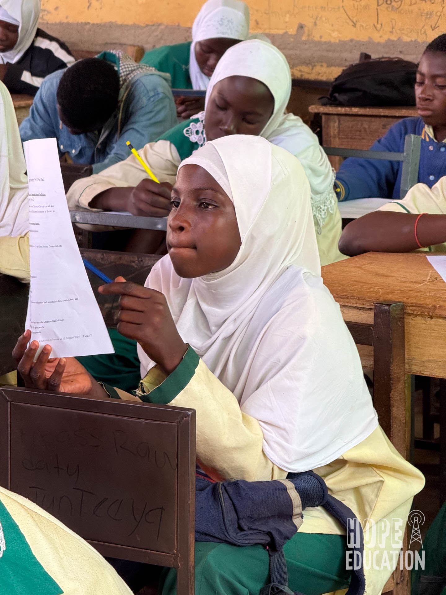 A student completes the M&E form for the Hope Education Project human trafficking education pilot in Tamale, Ghana