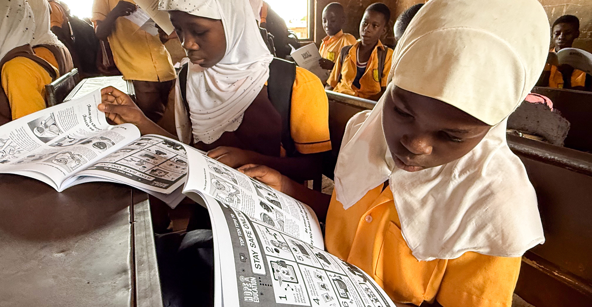 A pupil at Darrul Haddis JHS Tamale reading the handout for the Hope Education Project human trafficking education program for Ghana